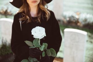 grieving woman holding white rose