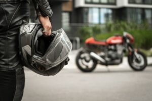 man gearing up to ride motorcycle