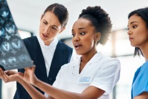 team of doctors reviewing brain mri