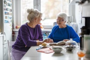 daughter talking with mother at nursing home