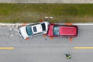 overhead view of red and white cars in a crash