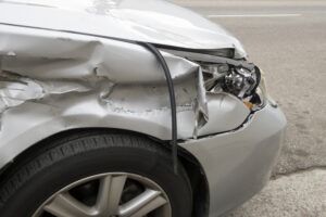 A crushed front-end of a car after a delivery truck accident. What damages can I recover?