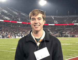 2025 Second Chance Scholarship winner Christopher Dailey smiling while attending a football game at Notre Dame.