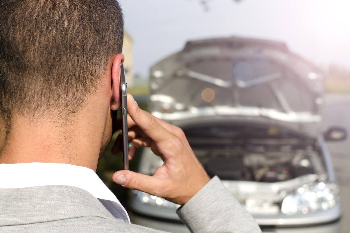 A man calling his lawyer after a hit-and-run accident.