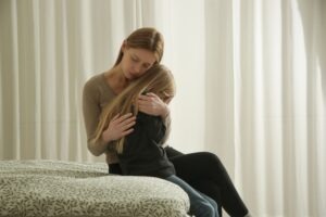 A mother consoling her child who has been sexually abused.