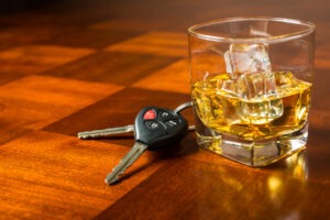 A set of keys next to a glass of whiskey. What do I do after a drunk driving accident in Las Vegas?