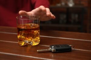 A key next to a glass of whiskey. Can you report a drunk driver after the fact?