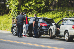 Police talking to a car accident witness and taking their statement