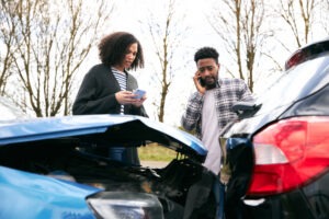 A man and a woman in a car after a car accident. How much compensation can you get from a car crash in Las Vegas?